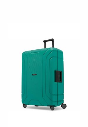 Turkooise hardshellkoffer met vier zwenkwieltjes, uitgetrokken telescopische hendel en zijkomende combinatieslot.
