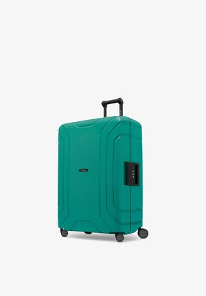 Valigia rigida color verde acqua con quattro ruote rotanti, manico telescopico esteso e serratura laterale con combinazione.