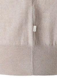 Maglione beige chiaro lavorato a maglia con polsini e orlo a coste. Tessuto strutturato con un motivo delicato. Piccola etichetta visibile sulla cucitura laterale.