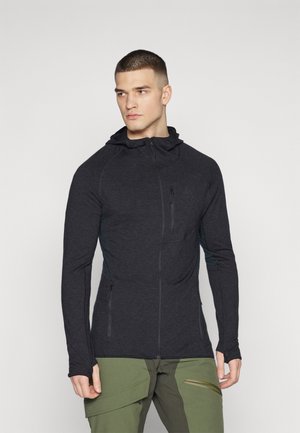 Black athletic hooded jacket with a fitted design, zippered pockets, and stretchable fabric, paired with khaki cargo pants.