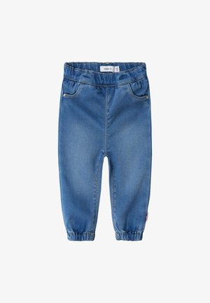 Blå denim joggebukser med elastisk midje, stramme mansjetter, frontlommer og et subtilt falmningsmønster. Merkelappen er synlig på innsiden.