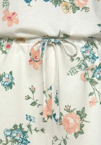 Floral-patterned white fabric with pink, blue, and green flowers; features a drawstring waist with matching decorative tie.