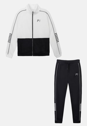 Tracksuit featuring a white zip-up jacket with black accents and striped details, paired with black tapered pants with white piping.
