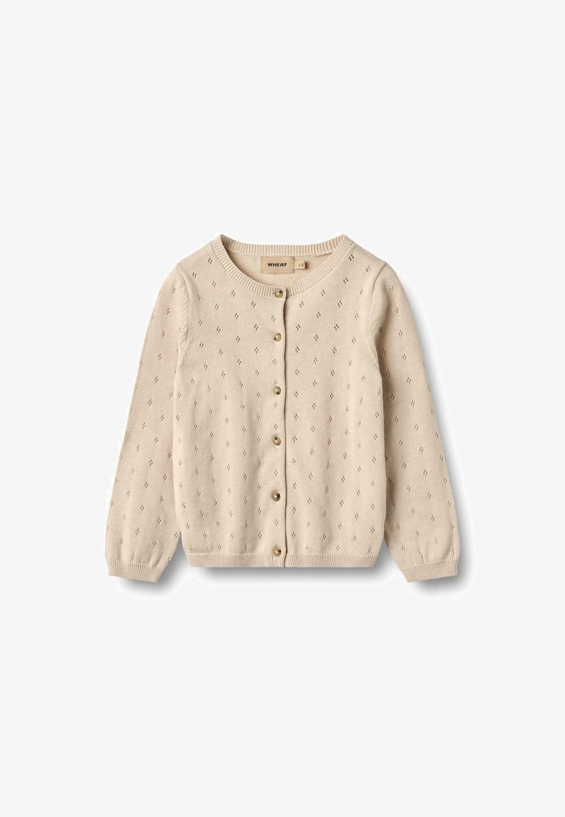 Cardigan en tricot beige avec un col rond, une fermeture à boutons et des motifs œillets décoratifs sur l'ensemble du tissu. Texture lisse.