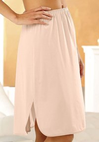 Beige, knielanger Rock aus weichem Stoff mit einem elastischen Bund und seitlichen Schlitzen für mehr Bewegungsfreiheit. Schlichtes Design, keine Muster.