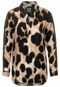 Blusa con stampa leopardata caratterizzata da colori nero, marrone e crema, un colletto e un'apertura con riflessi verdi lungo le maniche. Design a maniche lunghe.