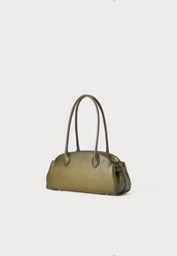 Olive green leather handbag with two elongated handles, rounded shape, smooth texture, and subtle hardware accents at the base.