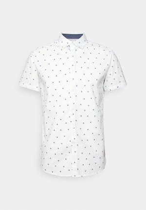 Chemise blanche à manches courtes avec petits imprimés de palmiers bleus et col pointu sur fond uni.