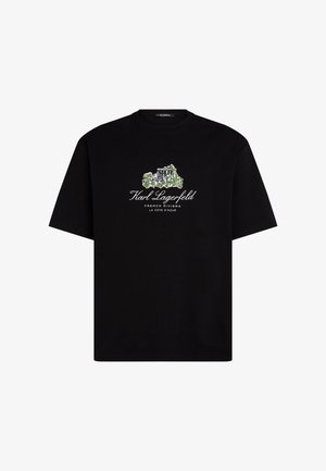 Černé bavlněné tričko s grafickým motivem budovy se zelenými akcenty. Texty uvádějí "Karl Lagerfeld", "Francouzská riviéra" a "La Côte d'Azur".