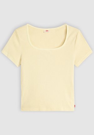 Hele-kollane sooniline lühikeste varrukatega särk, millel on lai ümmargune kaelus ja lühike lõige. Selja keskosas on nähtav silt.