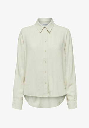 Camisa de manga larga color beige claro, hecha de una tela suave, con cuello, botones en el frente y dobladillo redondeado con aberturas laterales.