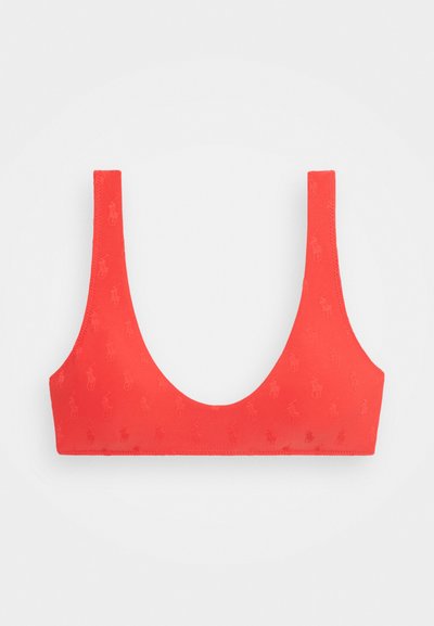 Κόκκινο σπορ σουτιέν με διακριτό ανάγλυφο σχέδιο με άλογα, φαρδιές τιράντες και στρογγυλή λαιμόκοψη σε λευκό φόντο.