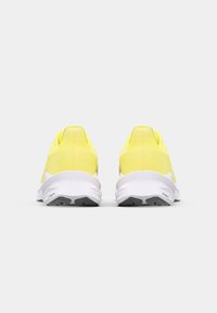 Lightweight running shoes with a bright yellow textile upper and white cushioning midsole. Features a textured design and durable rubber outsole.