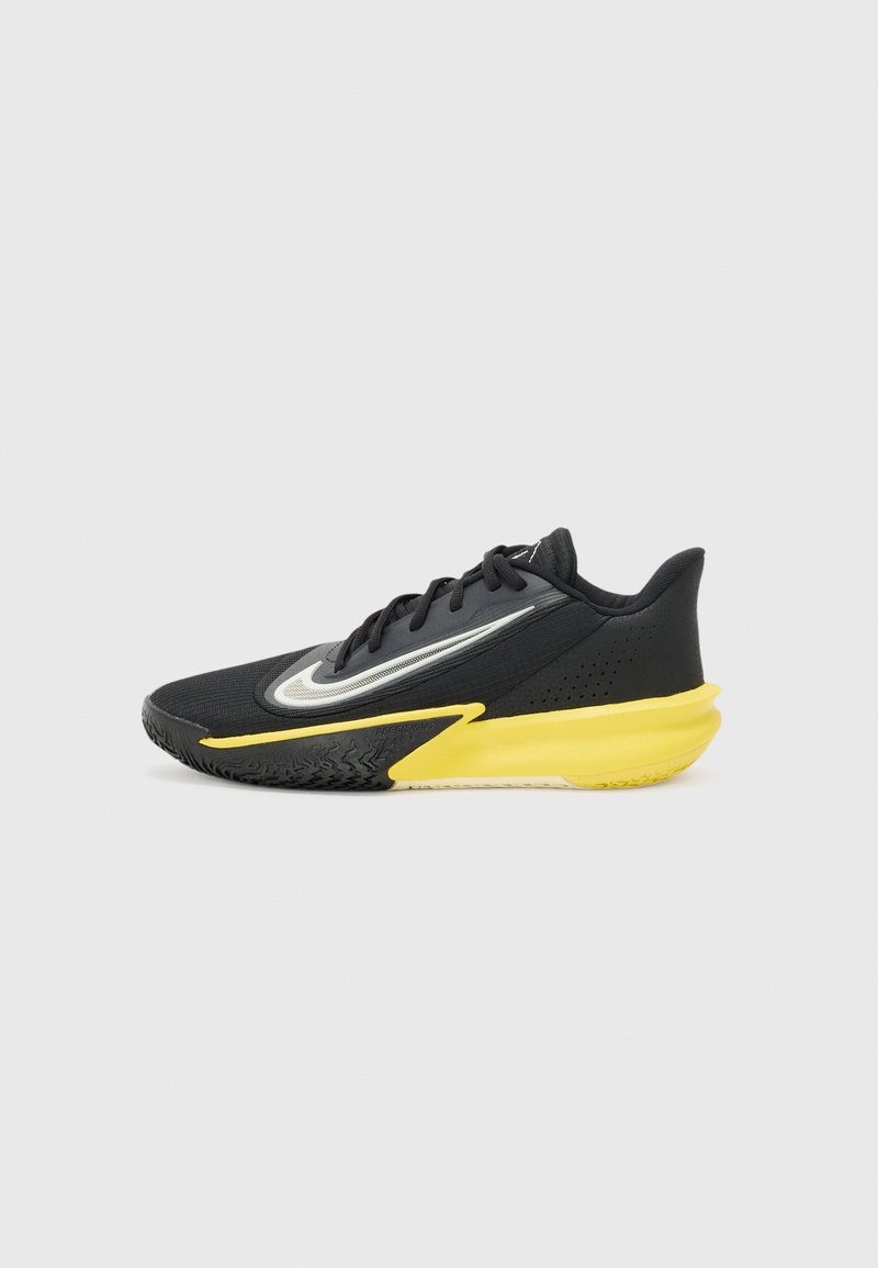 Black athletic shoe with yellow accents, mesh upper, textured sole, and a streamlined design. Features reflective logo and lace-up closure.