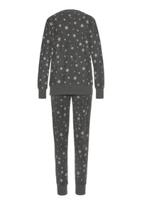 Fleece pajama set featuring a grey color with star patterns. The top has long sleeves and ribbed cuffs, while the pants have a fitted design.