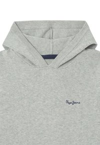 Sudadera gris con cuello acanalado, un acento en azul marino en el interior de la capucha y un pequeño logo bordado en la esquina inferior. Textura de tela suave.