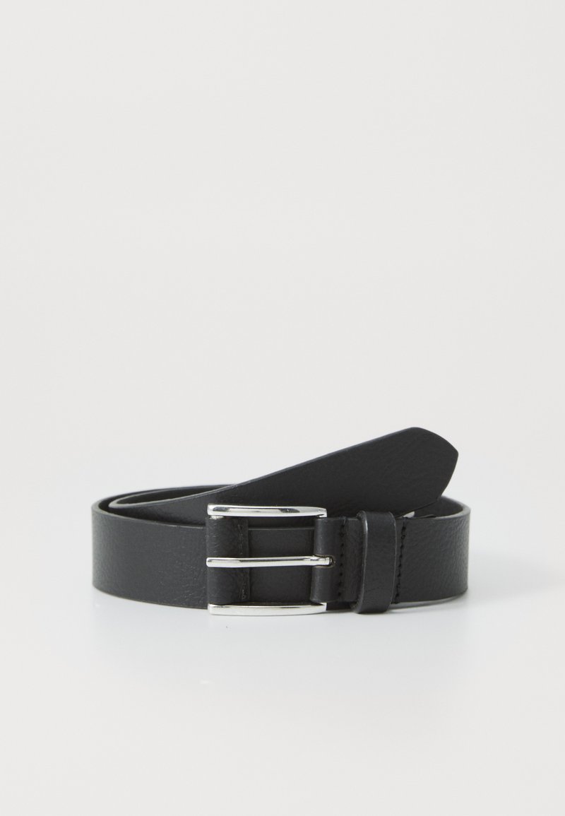 Black leather belt with silver metal buckle, rolled up on a white surface.