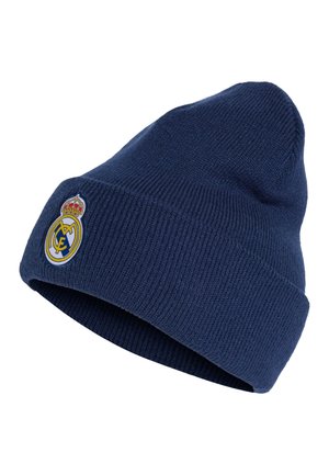 Donkerblauwe gebreide muts met omgeslagen rand en het embleem van voetbalclub Real Madrid aan de voorkant.