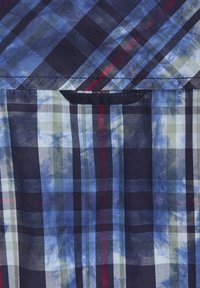 Karierte Bluse in Blau-, Grün- und Rottönen mit abwechselnd dicken und dünnen Streifen. Glatter Stoff mit strukturiertem Design und Tasche.