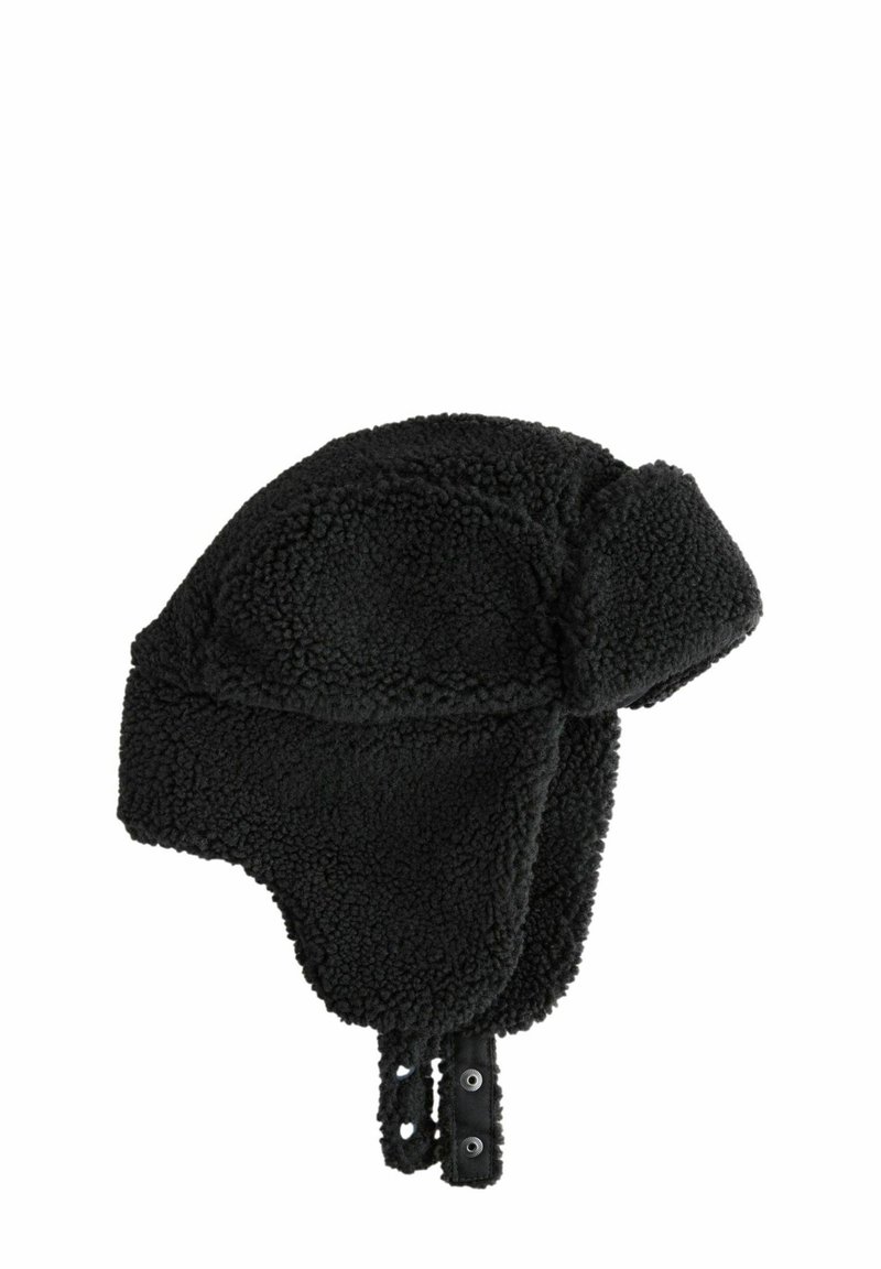 Black faux shearling trapper hat with ear flaps, showing a textured, fluffy surface and buttoned straps for secure fastening.