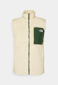 Beige Fleece-Weste mit hohem Kragen, grünem Reißverschluss und Fronttasche. Texturiertes Material mit glattem Rücken, versehen mit dem Logo von The North Face.