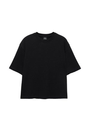 Prosty, czarny, oversize’owy t-shirt z krótkim rękawem i okrągłym dekoltem, rozłożony na płasko na białym tle.