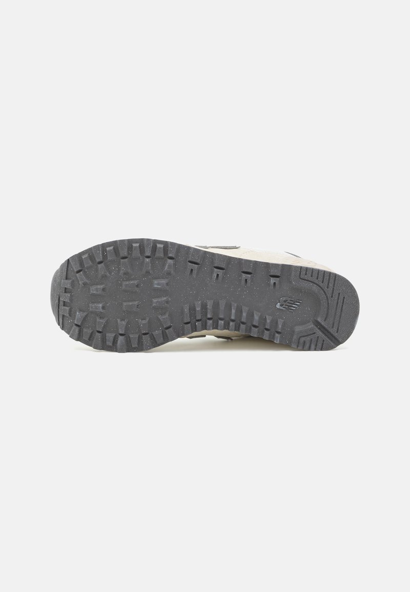 Sneakersohle, schwarzes Gummi mit Profilmuster, strukturiert. Oberer Teil aus hellbeigem Material, minimales Design, mit einem dezenten Logo-Detail.