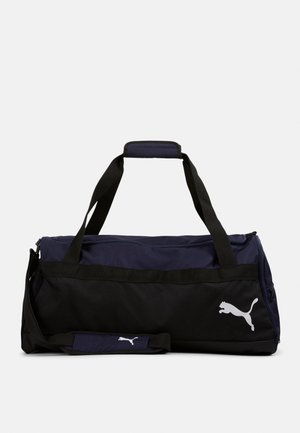 Navy- und schwarze Duffle-Tasche mit doppelt vorhandenen Griffen, verstellbarem Schultergurt, Reißverschluss oben und weißem Puma-Logo. Aus strapazierfähigem Material.