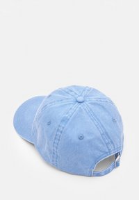 Light blue cotton baseball cap with six panels, curved brim, centered button, and adjustable strap at the back. Textured fabric.