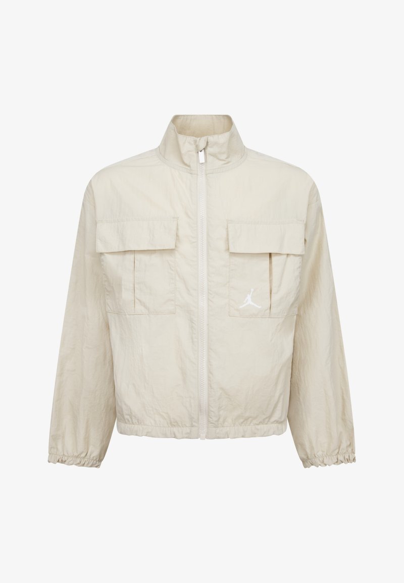 Cream zip-up jacket made of lightweight material, featuring two front pockets, elastic cuffs, and a white logo detail on the chest.