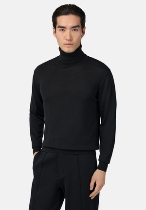 Schwarzer Rollkragensweater aus weichem, gestricktem Stoff. Hat ein tailliertes Design, lange Ärmel und gerippte Bündchen sowie einen gerippten Saum.