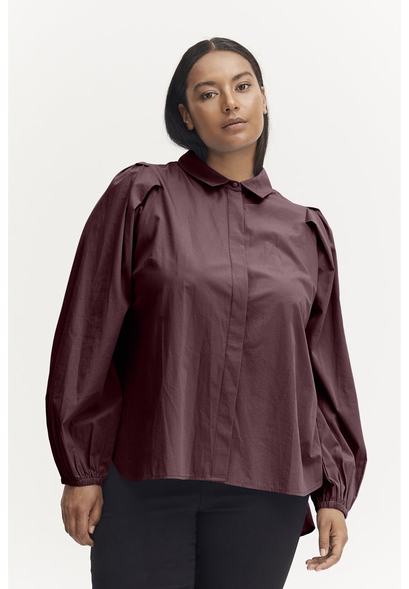 Burgundy button-up shirt with a collar, puffed long sleeves, and elastic cuffs. Made from smooth, lightweight fabric with a structured fit.