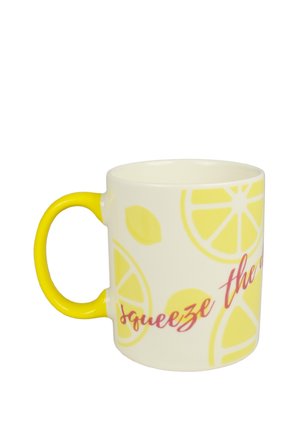 White ceramic mug with yellow handle, decorated with lemon slices and red text reading "squeeze the".