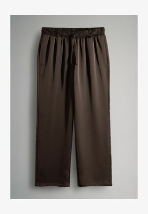 Kerged, kerge pruun satiin kangast püksid elastse vöökoha ja reguleeritava paelaga. Omavad laia jala lõiget ja siledat tekstuuri.