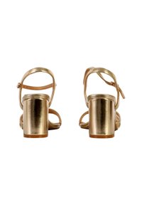 Gold metallic heeled sandals with a square block heel, ankle strap, and open-toe design; smooth texture with adjustable buckle detail.