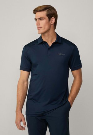 Navy blue polo shirt in moisture-wicking fabric with a two-button placket, short sleeves, and embroidered "HACKETT SPORT" logo on the chest.