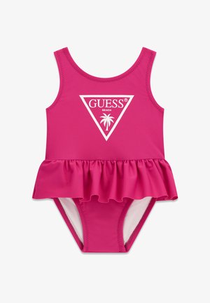 Φωτεινό ροζ μαγιό για παιδάκι με φούστα βολάν, αμάνικο σχέδιο και λευκό λογότυπο «GUESS Beach» με φοίνικα στο μπροστινό μέρος.