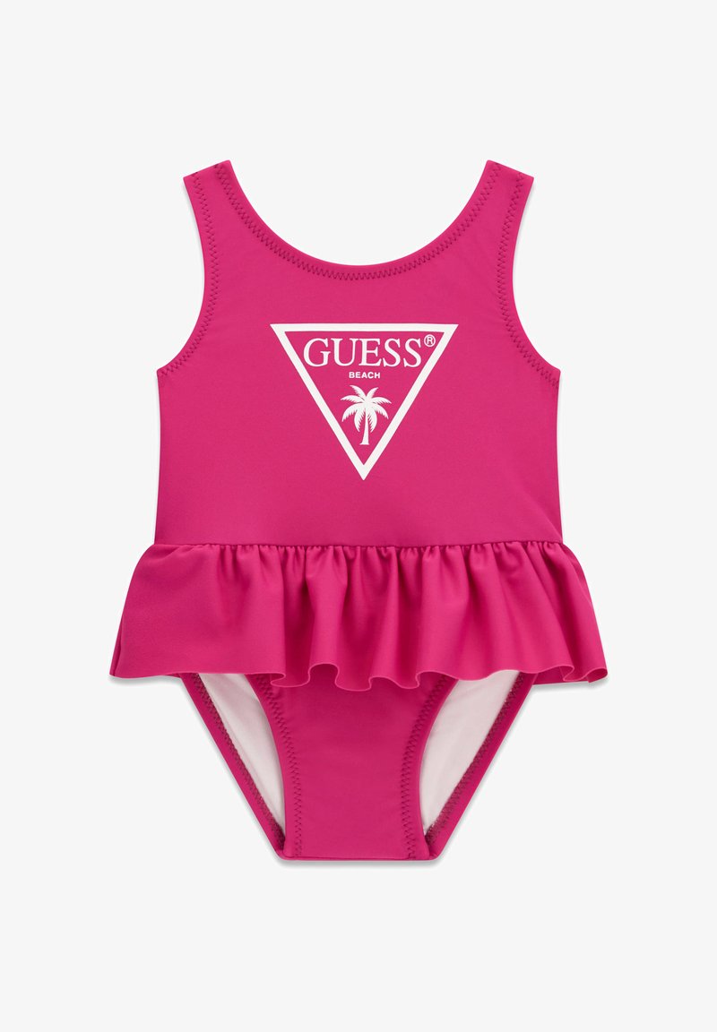 Φωτεινό ροζ μαγιό για παιδάκι με φούστα βολάν, αμάνικο σχέδιο και λευκό λογότυπο «GUESS Beach» με φοίνικα στο μπροστινό μέρος.