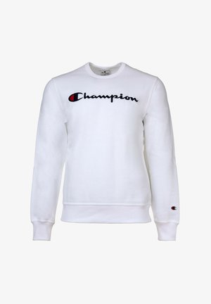 Sudadera blanca de manga larga, con cuello redondo y logo Bordado de "Champion" en negro. Presenta un parche con el logo en la manga izquierda.