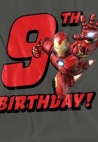 Red T-shirt featuring a cartoon Iron Man figure, with "9TH BIRTHDAY!" text in bold red and black. Shirt's background is gray, with a smooth texture.