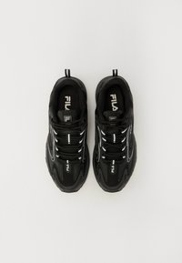 Black athletic shoes with mesh and synthetic material, round toe, lace-up design, and reflective accents on the sides. Fila logo on the tongue.