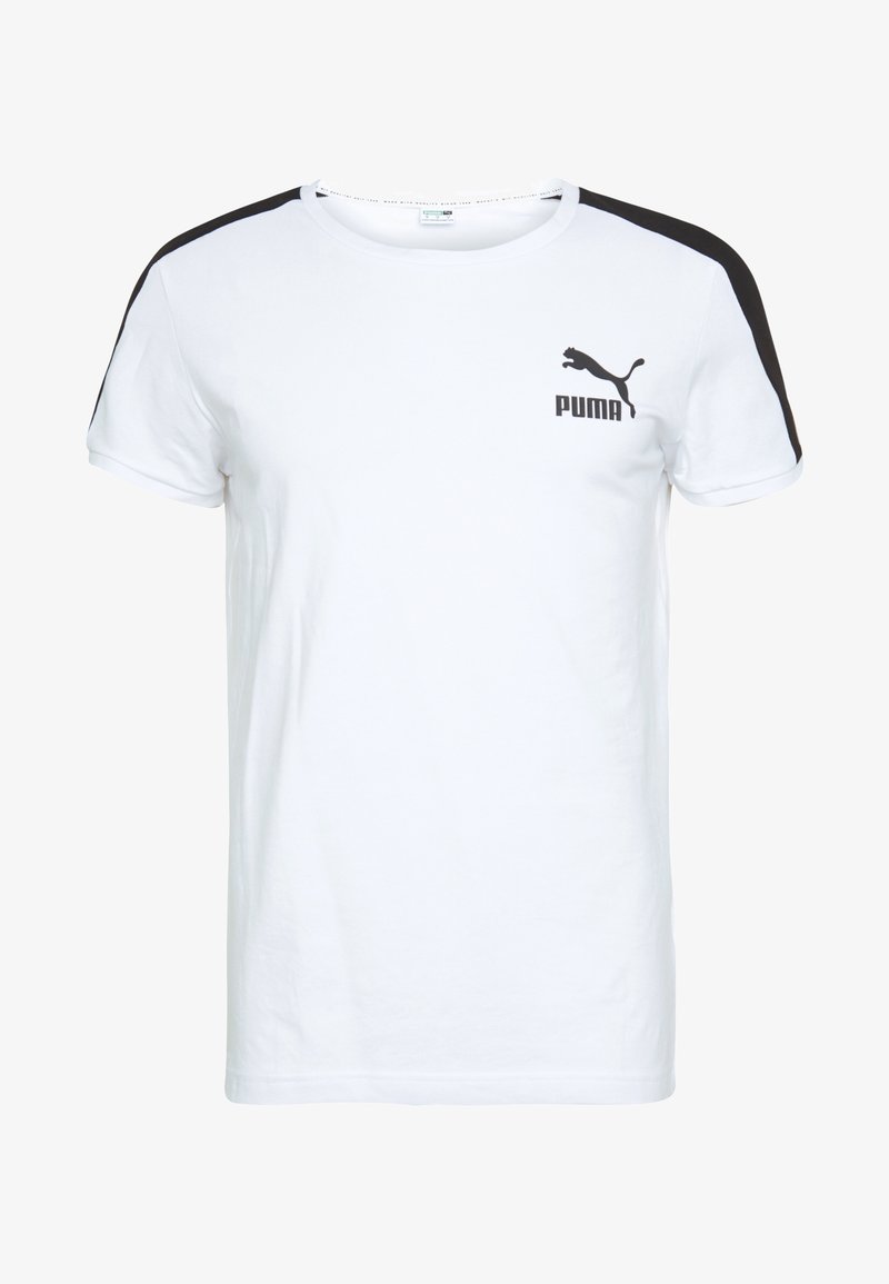 Bílý krátký rukáv tričko s černými akcenty na ramenou. Obsahuje černé logo Puma na levé straně hrudi. Vyrobeno z měkké bavlny.