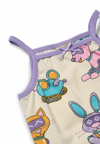 Mouwloos kindertanktopje met een crème basis, voorzien van kleurrijke cartoontierafdrukken. Afgewerkt met lila bies en een decoratieve strik.