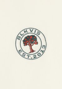 Embroidered patch featuring a tree with red fruits, surrounded by the text "BLK VIS EST. 2013" on a white background. Circular design.
