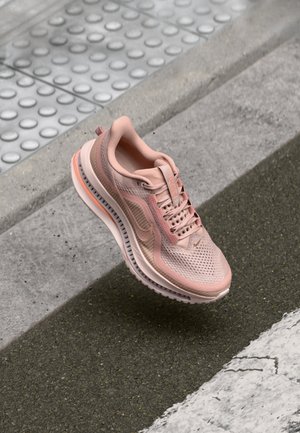 Light pink running shoe with a mesh upper, textured patterns, padded collar, and rubber sole, featuring a gradient midsole design.