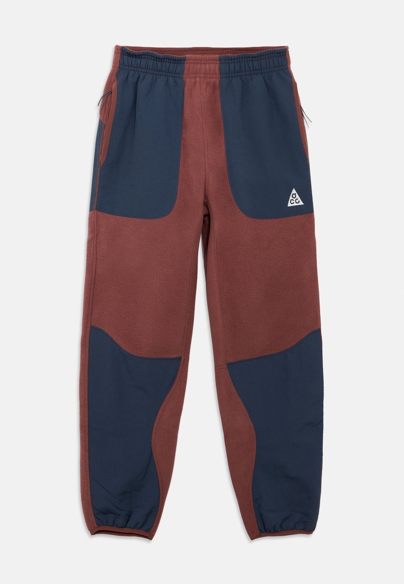 Sportinės kelnės iš fliso su spalvų blokų dizainu bordo ir tamsiai mėlynos spalvų, elastinga liemens juosta ir įstrižomis šoninėmis kišenėmis su logotipo akcentu.
