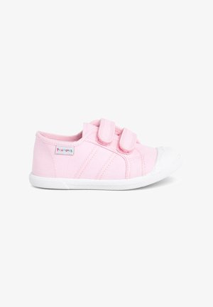 Pink fabric sneaker with two velcro straps, white rubber toe cap, and textured sole. Features diagonal stitching and a small logo tag.