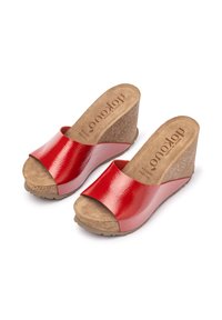 Red wedge sandals featuring a glossy patent upper and a cork footbed, with an open-toe design and textured rubber sole for traction.