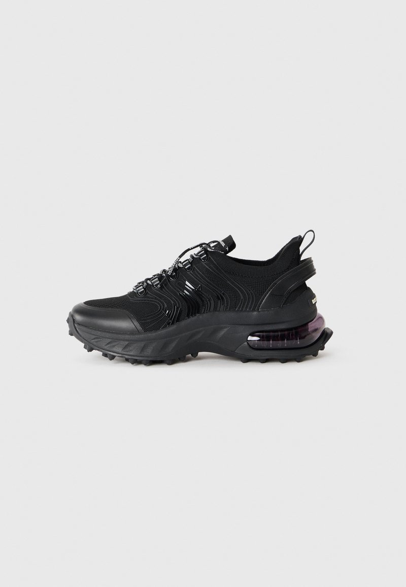 Black athletic shoe with a textured mesh upper and rubber sole. Features a purple air cushioning unit, lace-up design, and pull tab.