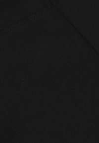Zwart katoenen stof met een gladde textuur, voorzien van subtiele stikdetails. Het materiaal lijkt dicht en heeft een uniforme kwaliteit.